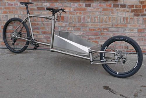 Catan titanium Cargobike lightweight mixed surface gravel cargo bike unique linkage arm steering engineered flex complete angled