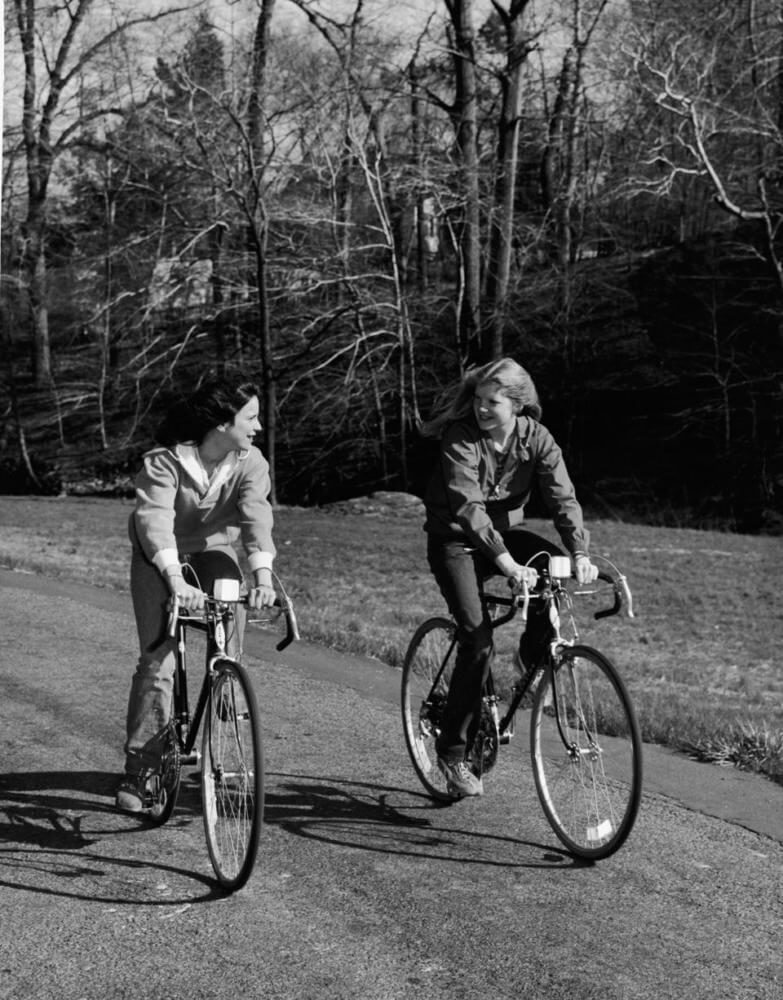 Two young women ride Schwinn road bicycles 1970s.